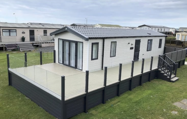 Wrap-around composite deck with glass balustrade built by ACE GROUP