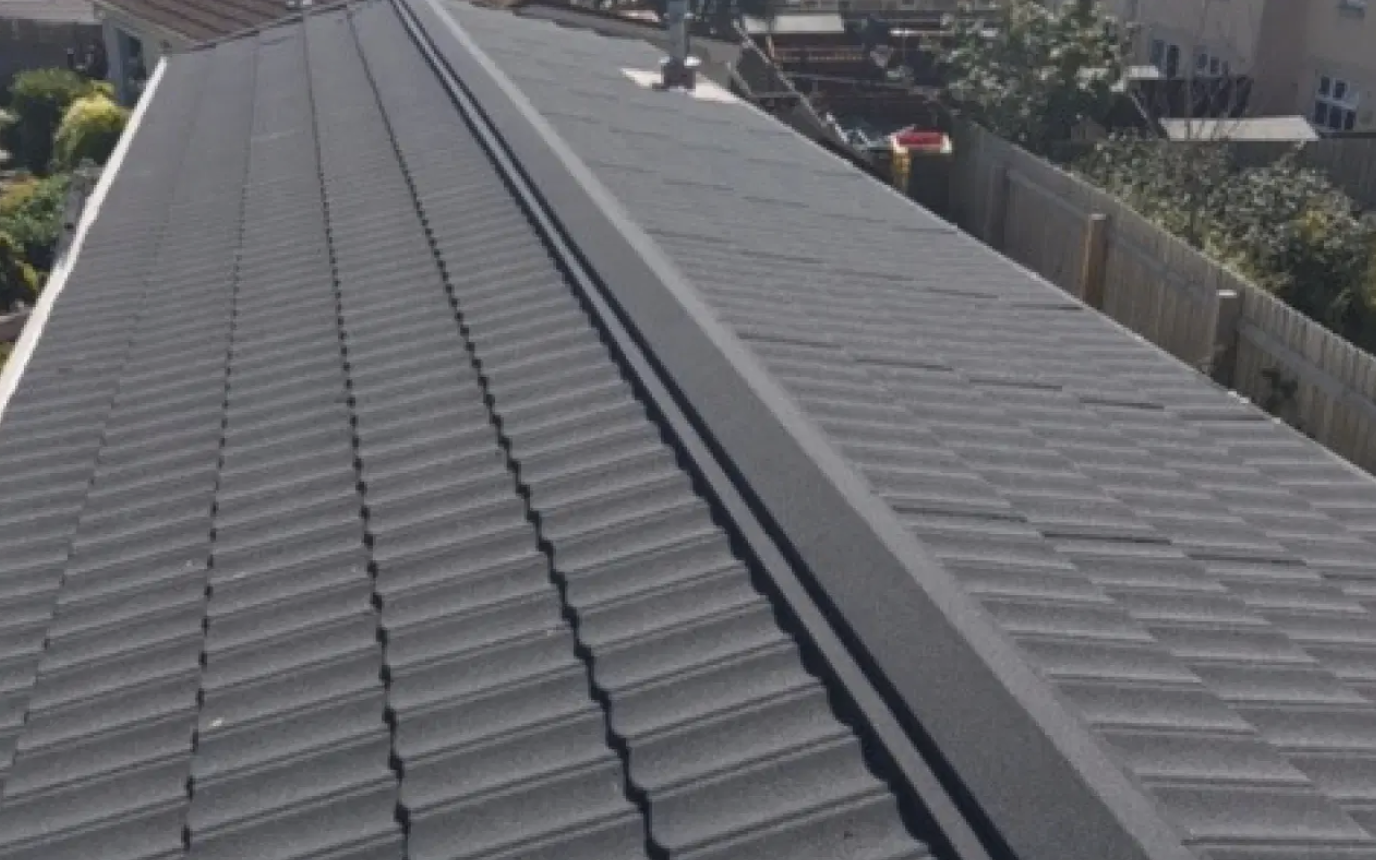 Charcoal roof tiles and ridge cap on a parkhome by ACE GROUP
